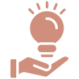 Hand holding a glowing light bulb.