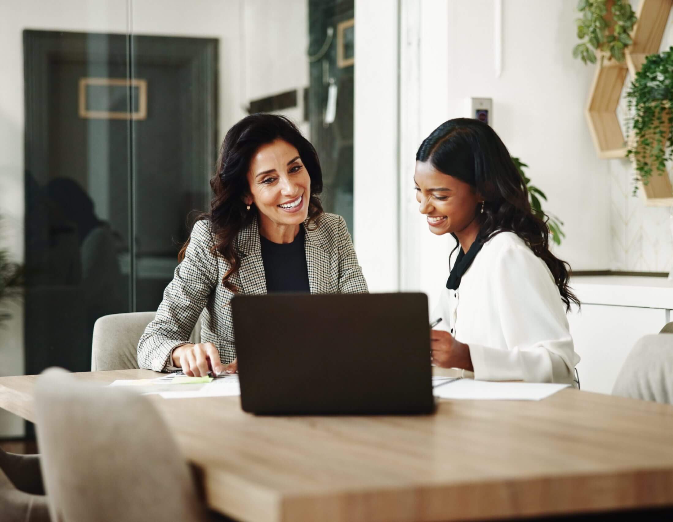 Two women working together at a table.